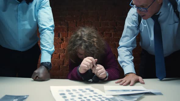 Aggressive Police Officers Yelling at Scared Woman Suspect During Interrogation