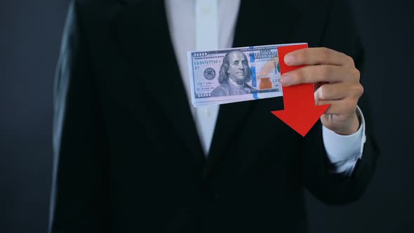 Financial Consultant Holding Dollar Banknotes Showing Thumbs Down, Falling