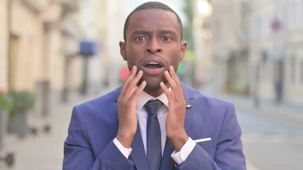 Outdoor Excited African Businessman Reacting to Loss