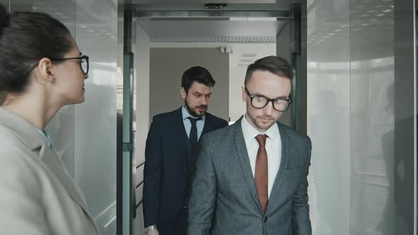 Team of Lawyers Walking into Elevator in Office