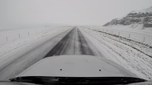 Driving in Iceland across icy countryside and snowy mountains