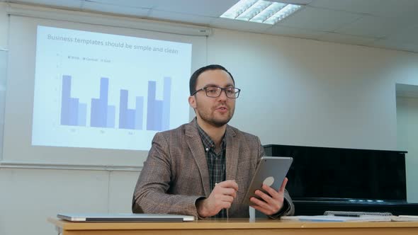 Teacher Teaching Kids on Digital Tablet in Classroom at School