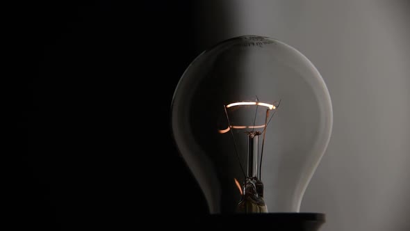 Closeup Incandescent Lamp Flashes on a Dark Background