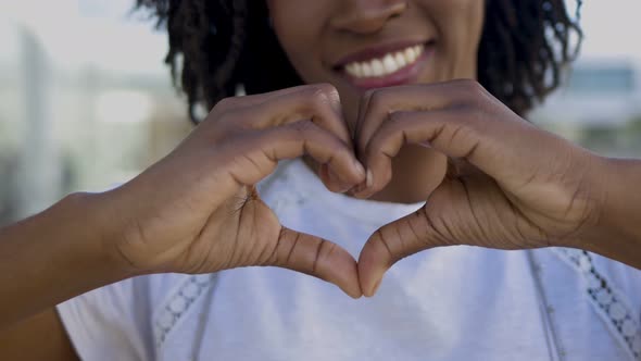 Closeup View of Female Hands Making Heart Shape