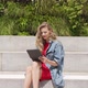 Young Woman Using Tablet While Sitting on Street - VideoHive Item for Sale