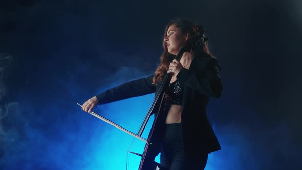 Young Beautiful Woman Playing a Melody on Cello, Smoky Dark Studio