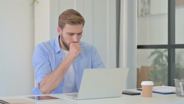 Sick Young Creative Man at Work Having Cough