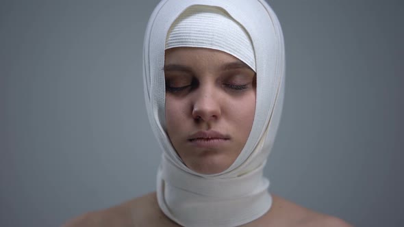 Female Patient in Headwrap Looking to Camera, Rehabilitation After Car Accident