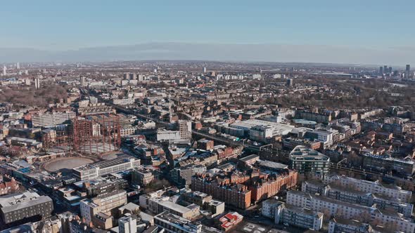 dolly back drone shot of residential London clear day after snow Tower hamlets