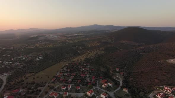 Aerial Scene of Cottages, Green Landscape with Hills and Plains in Greece