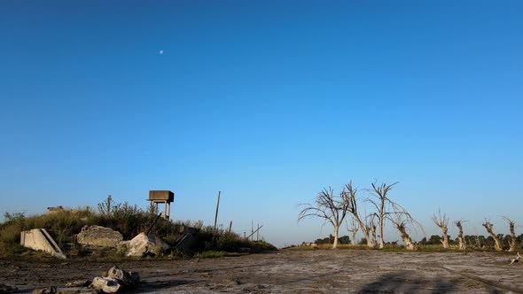 Aerial ground level drone flying low across the uninhabited ghost town villa Epecuen against cloudle