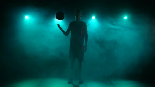 Silhouette of a Young Guy Basketball Player Tossing the Ball Up