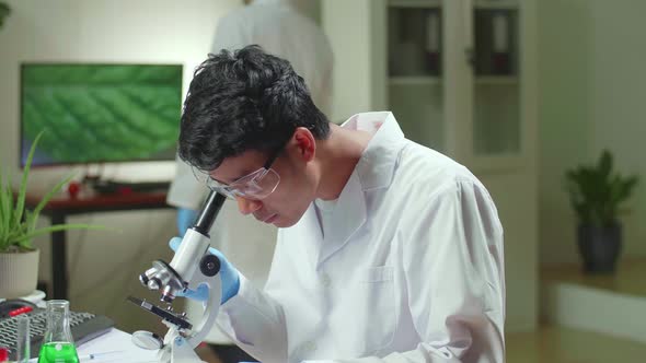 Biochemistry Doctor Examining Chemical Test Using Microscope For Genetic Researcher alt