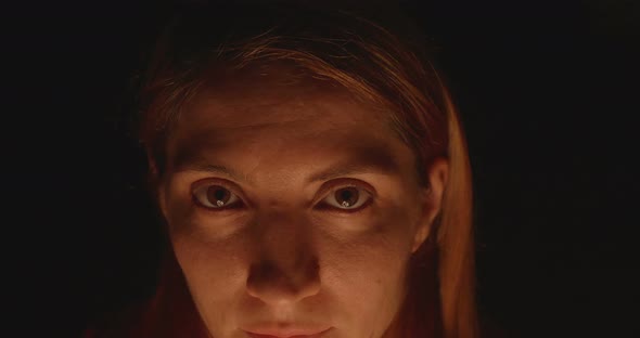 Woman Eyes In Darkness And Candle Light