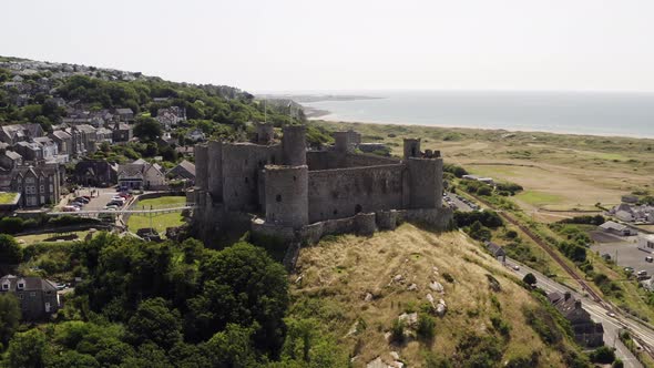 Harlech castle in North Wales, Gwynedd, UK, shot by drone to show proximity of the castle against th