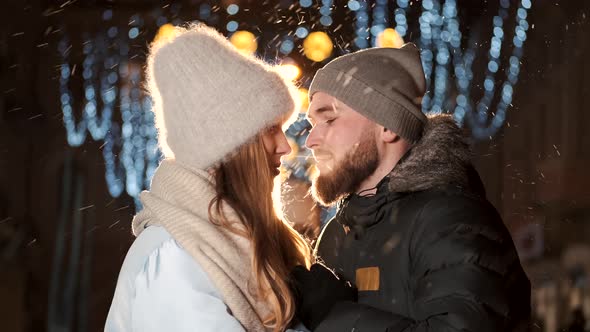 An Attractive Couple in Love a Stylish Couple Wearing Warm Clothes Cuddling Together and Looking