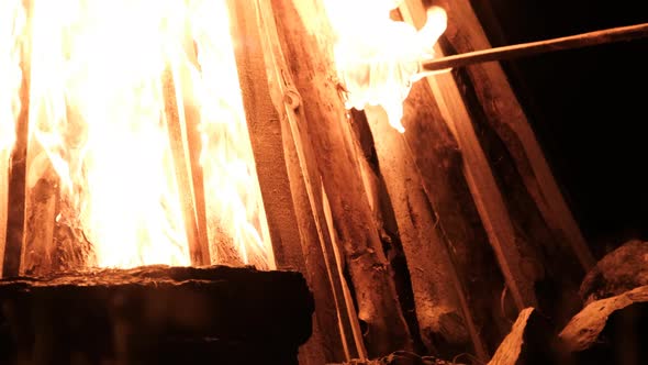 Setting Big Bonfire at Night in Slow Motion on a Black Background on Nature