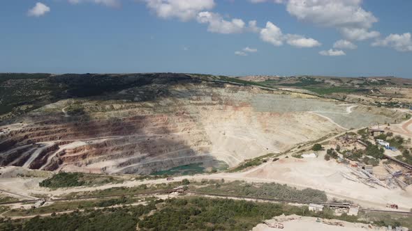 Aerial View Industrial of Opencast Mining Quarry with Lots of Machinery at Work Extracting Fluxes