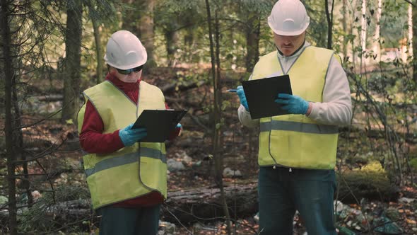 Man Woman Environmentalists Document Offense  Forest Pollution and Issue Fine