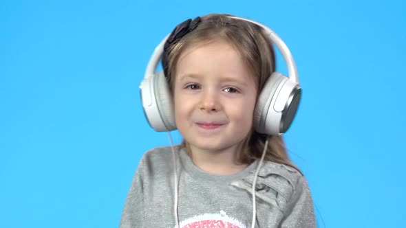 Girl Is Listening To the Music Through Headphones and Dancing