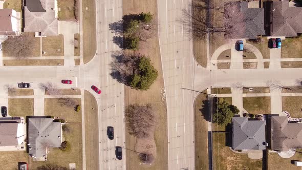 Vehicles Driving At Metro Parkway (16 Mile Road) Between Houses In Sterling Heights In Macomb County