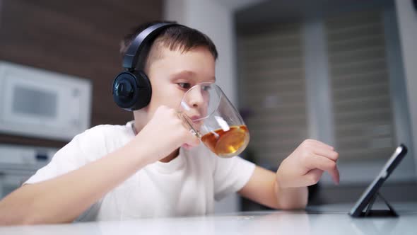 Boy Drinking Tea on Table alt