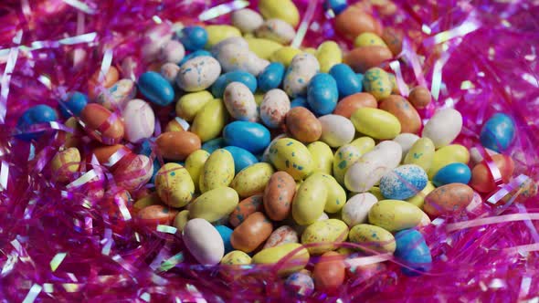 Rotating shot of colorful Easter candies on a bed of easter grass 