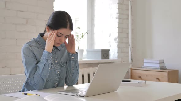 Young Girl with Headache at Work