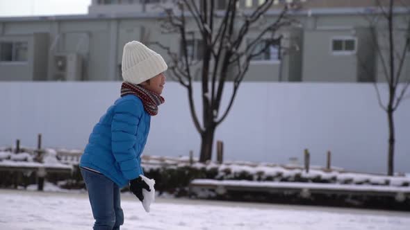 Cute Asian Child Playing Snow In The Park