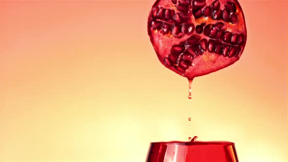 Super Slow Motion Pomegranate Juice Drips Into the Glass