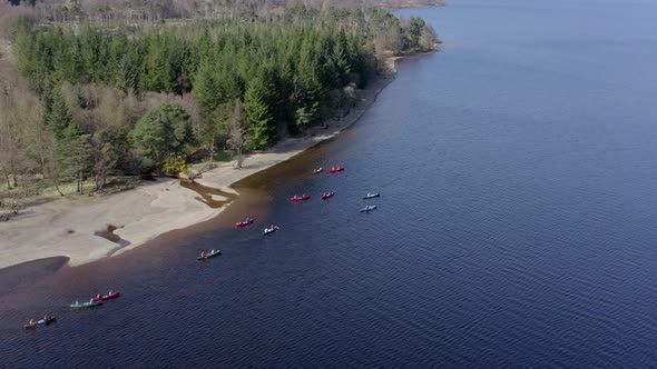 Canoeists Close to the Shore of a Lake During the Summer