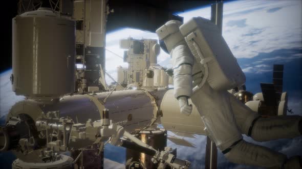 International Space Station and Astronaut in Outer Space Over the Planet Earth alt
