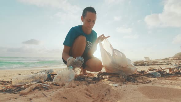 Caucasian Woman Volunteer Fights Climate Change By Cleaning Ocean of Garbage