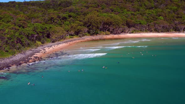 Surfers On The Turquoise Ocean At Noosa Heads, Queensland, Australia - aerial drone shot