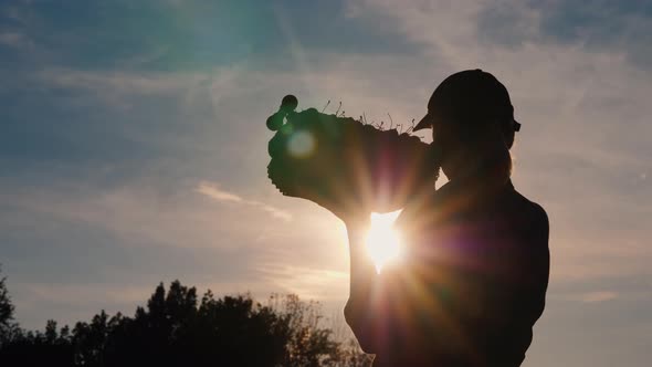 Silhouette of a Farmer with a Box of Fruit on His Shoulder