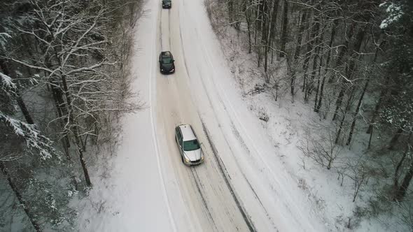 Aerial View of Car Moving in Winter Forest