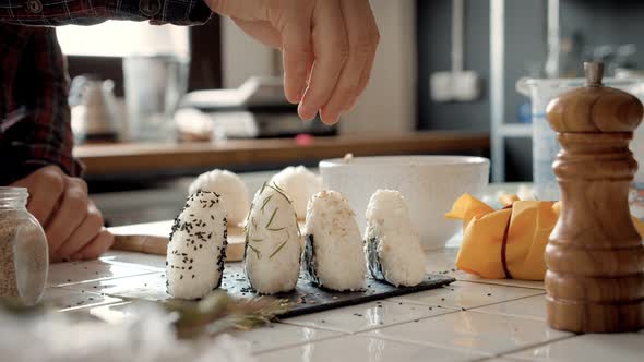 Chef or Cook Makes Japanese Onigiri Snack Recipe