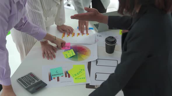 Business People Proficiently Discuss Work Project on Meeting Table