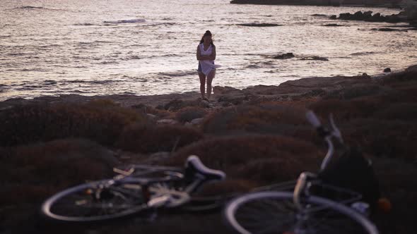 Smiling Young Woman Walking in Slow Motion on Sea Beach in Dusk on Cyprus