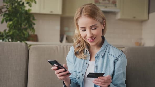 Woman 30s Makes Online Purchases in Smartphone with Bank Card at Home