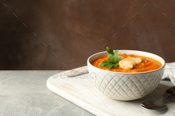 Composition with bowl of pumpkin puree with croutons on gray table / Photodune, Misc
