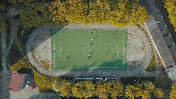 Football team practicing on a green soccer field