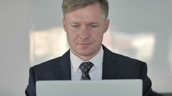 Close Up of Businessman Celebrating Success Working on Laptop