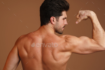 Shirtless athletic man showing his biceps at camera / Photodune, Misc