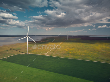 Aerial view of wind turbines and agriculture field near the sea at sunset / Photodune, Misc