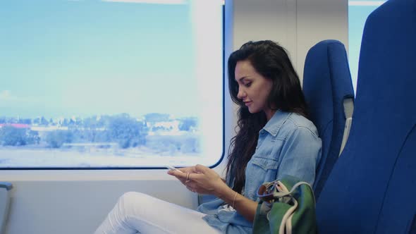 Trip By Train Female Passenger Is Using Smartphone During Voyage