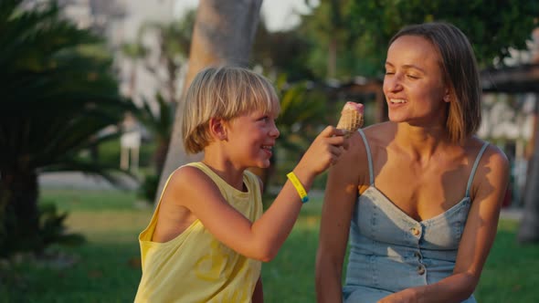 Close Up Shot of a Young Loving Family Clinking Ice Cream Cones and the Child Keeps on Eating His