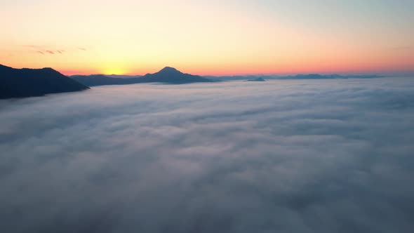 4K Aerial video Beautiful sunrise above dense clouds and fog in the morning