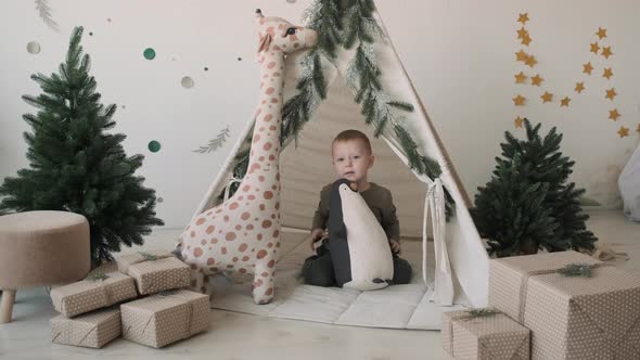 Happy Child Boy Playing with Toys in Christmas