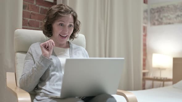 Old Woman Doing Video Chat on Laptop on Sofa